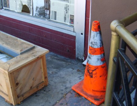 [image of store-front with planter pulled away]